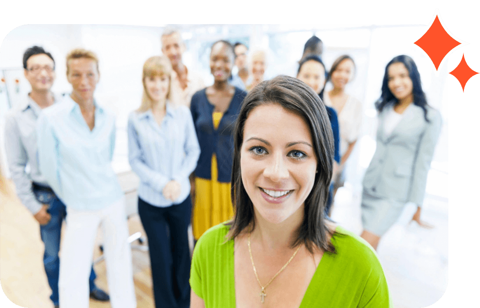 A group of people standing in a room with one woman smiling.